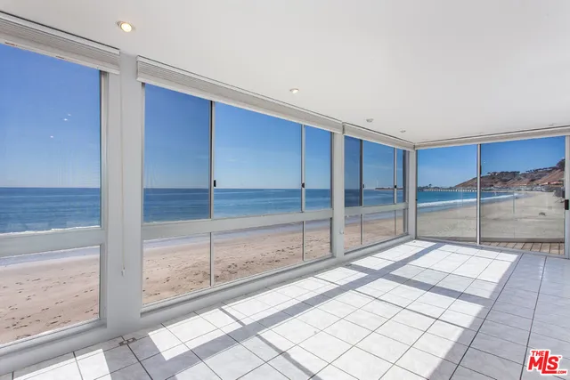a bathroom with a tub and view of floor to ceiling window
