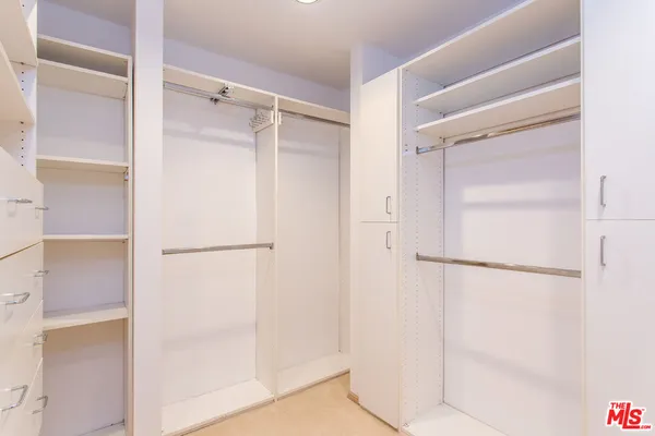 a kitchen with stainless steel appliances kitchen island granite countertop a refrigerator and a sink