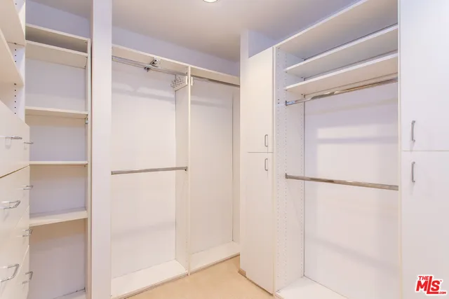 a kitchen with stainless steel appliances kitchen island granite countertop a refrigerator and a sink