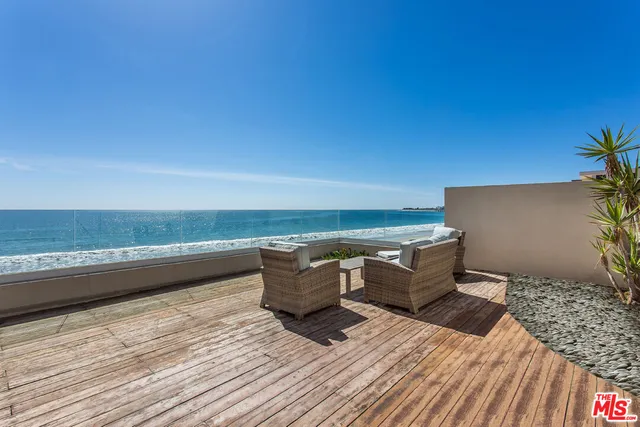 a view of a terrace with wooden floor and city view
