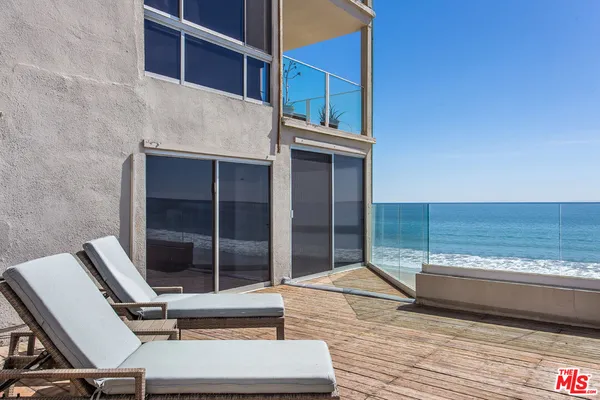 a view of balcony with wooden floor and seating space