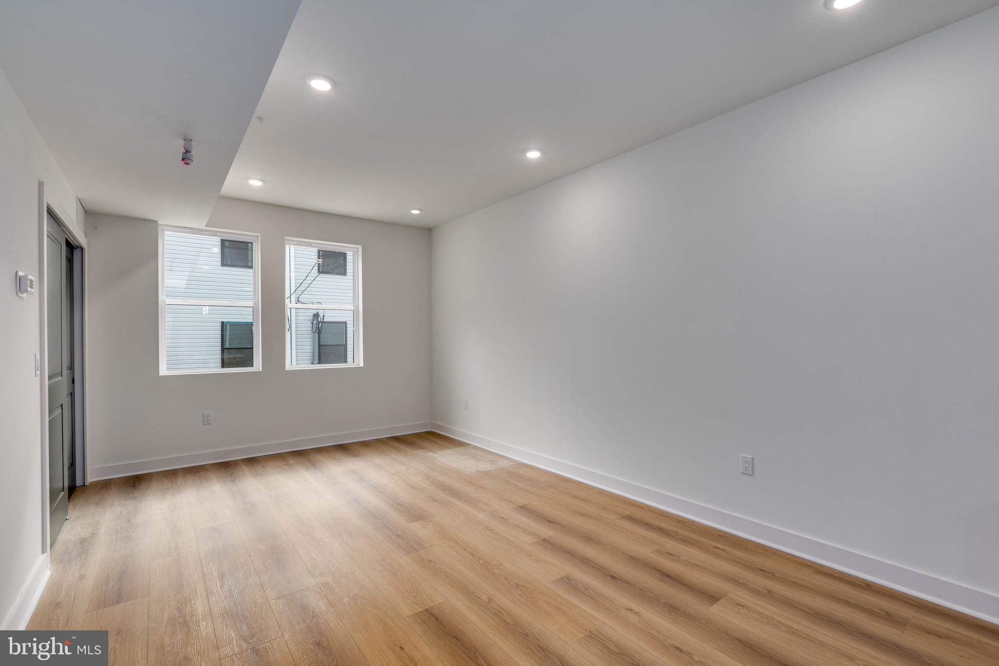 1224 West Silver Street, Unit 2 Philadelphia, PA 19133 - Photo 8 of 11 a view of empty room with wooden floor and fan