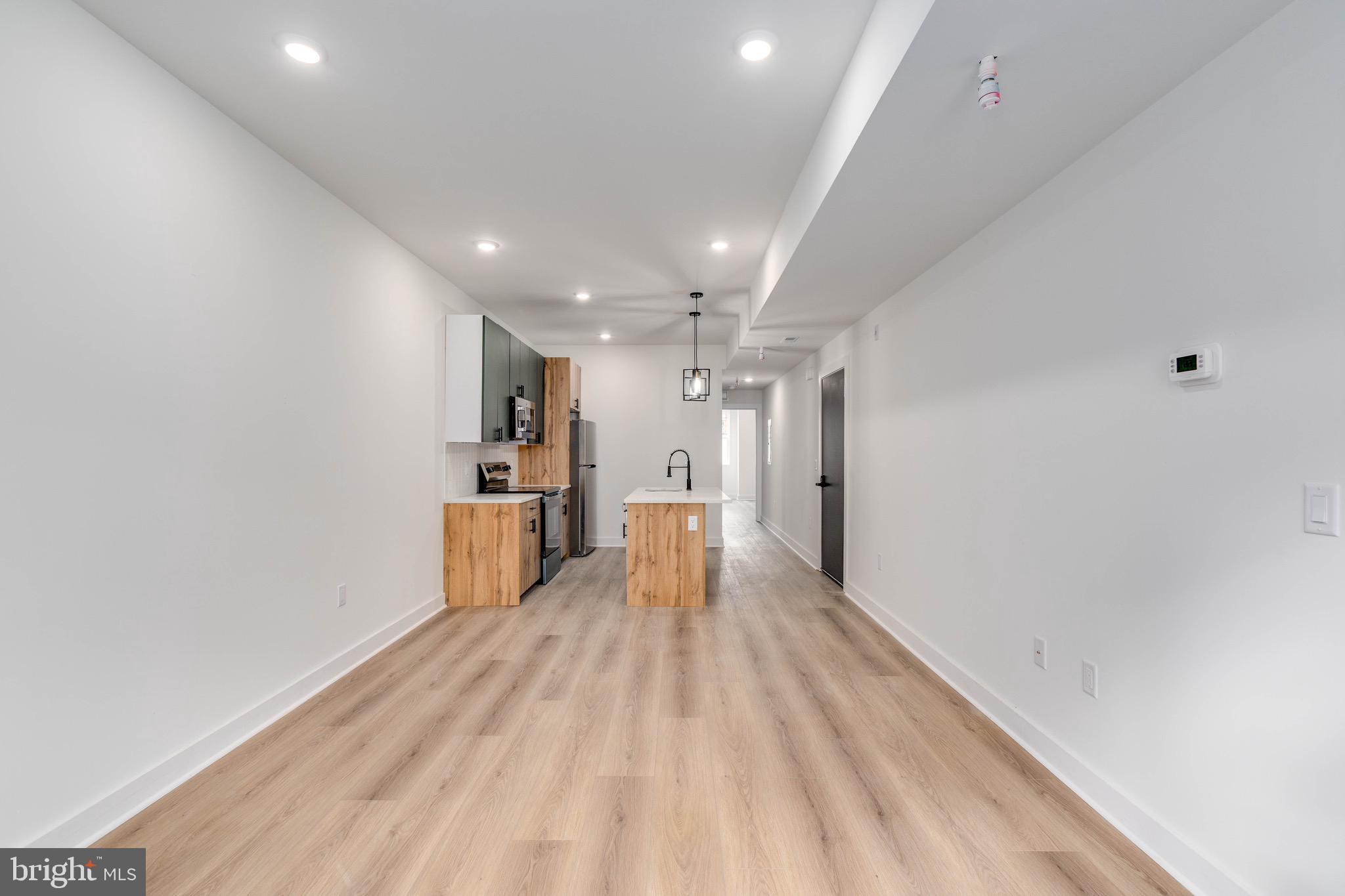 1224 West Silver Street, Unit 2 Philadelphia, PA 19133 - Photo 10 of 11 a view of a kitchen with a sink and wooden floor