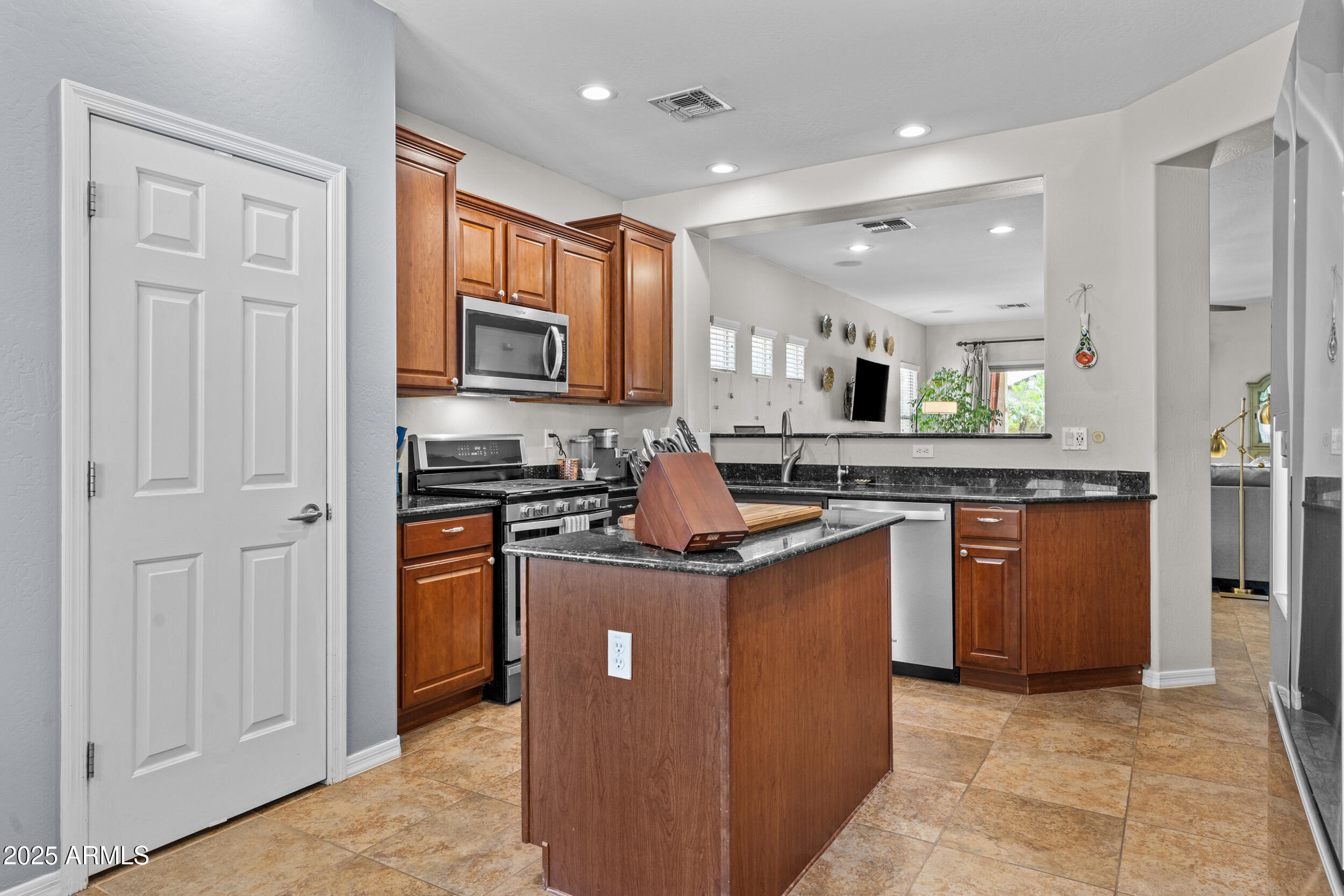 5303 West Hackamore Drive Phoenix, AZ 85083 - Photo 11 of 33 a kitchen with stainless steel appliances granite countertop a stove top oven and sink
