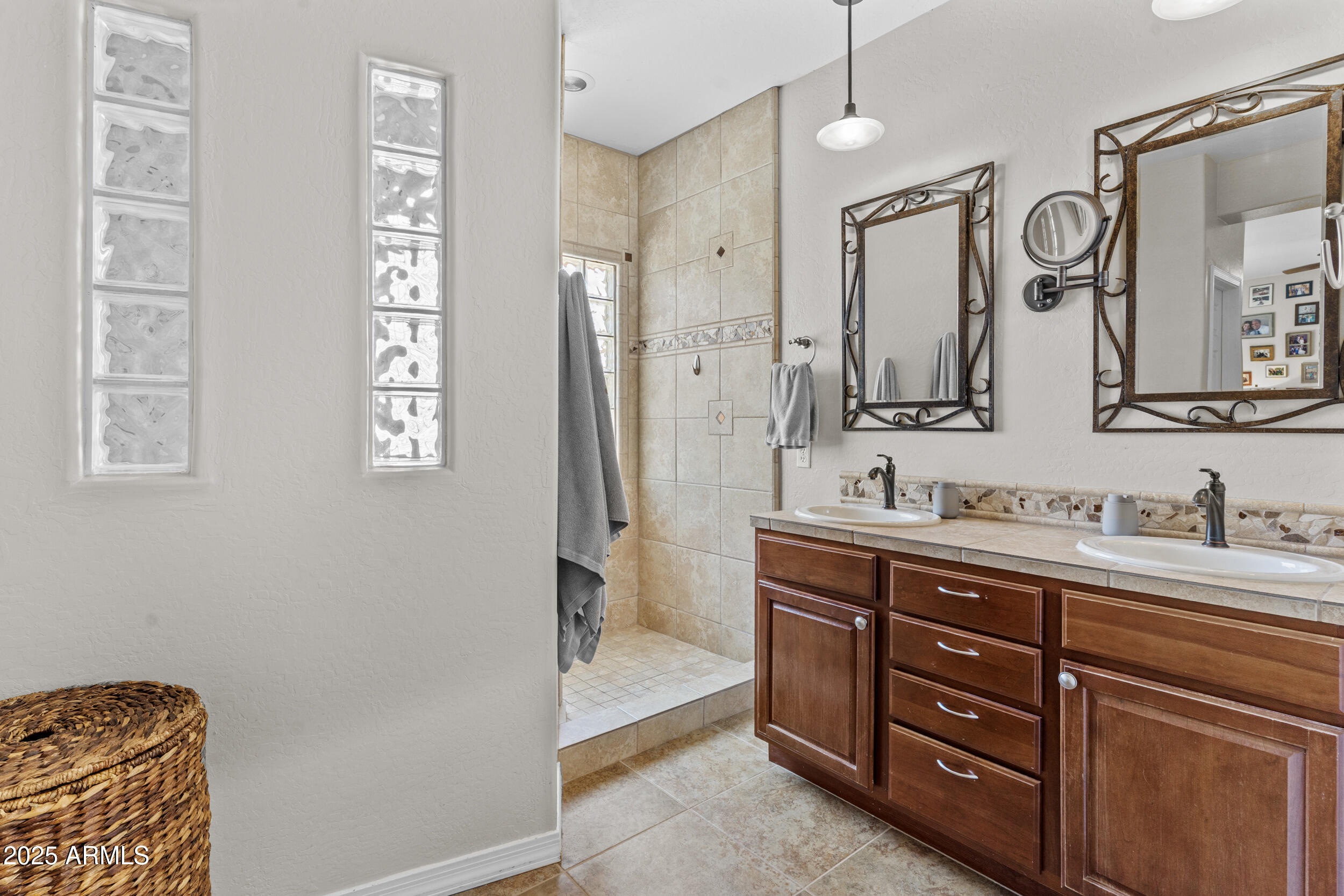 5303 West Hackamore Drive Phoenix, AZ 85083 - Photo 17 of 33 a spacious bathroom with a granite countertop sink a mirror a vanity and a shower