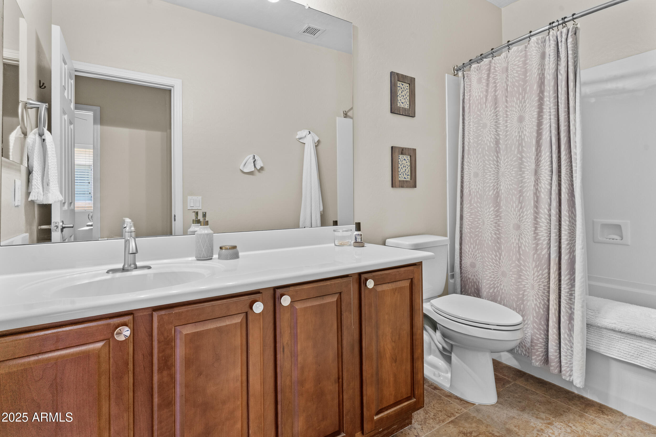 5303 West Hackamore Drive Phoenix, AZ 85083 - Photo 21 of 33 a bathroom with a double vanity sink toilet and a mirror