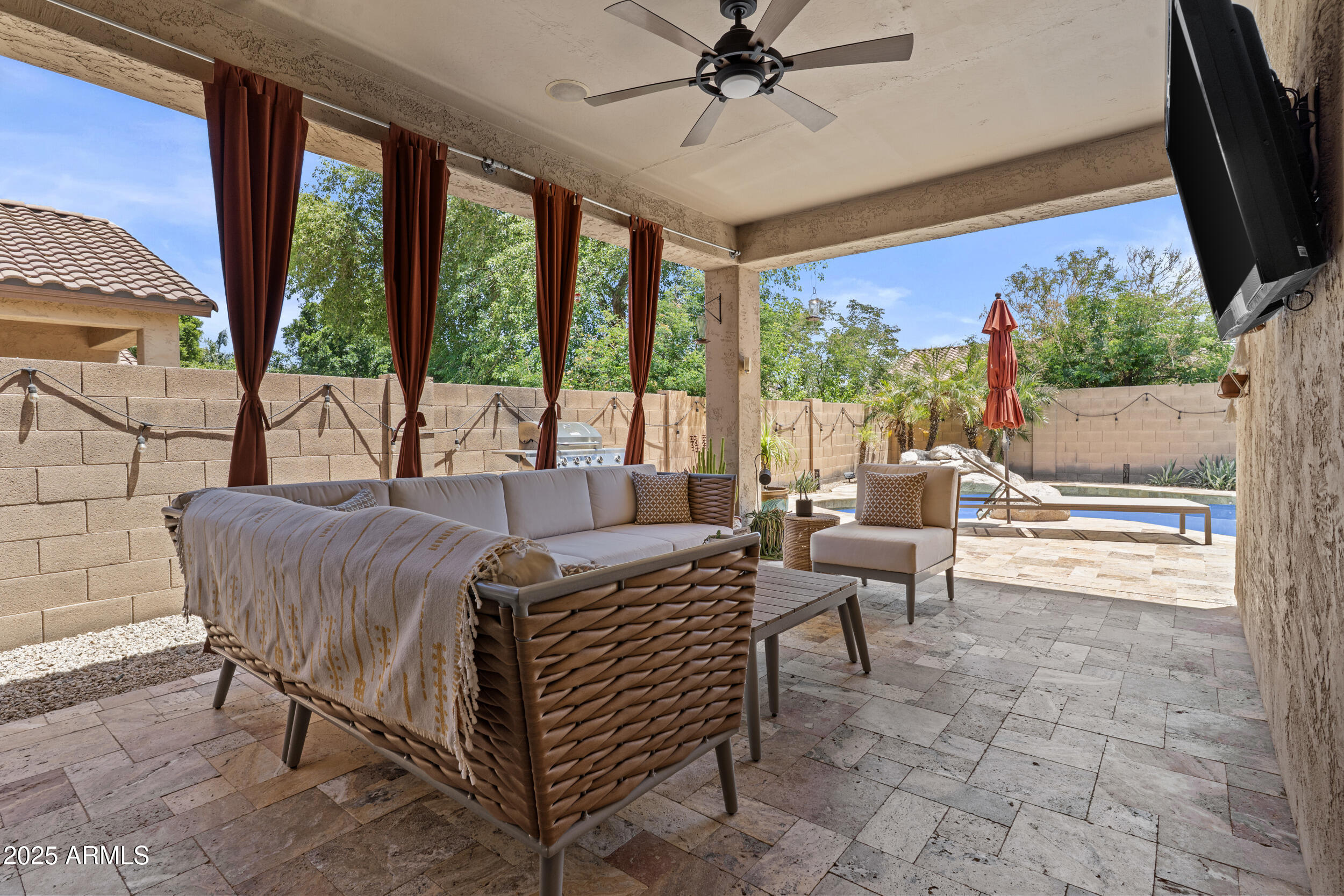 5303 West Hackamore Drive Phoenix, AZ 85083 - Photo 24 of 33 a living room with furniture a flat screen tv and a floor to ceiling window