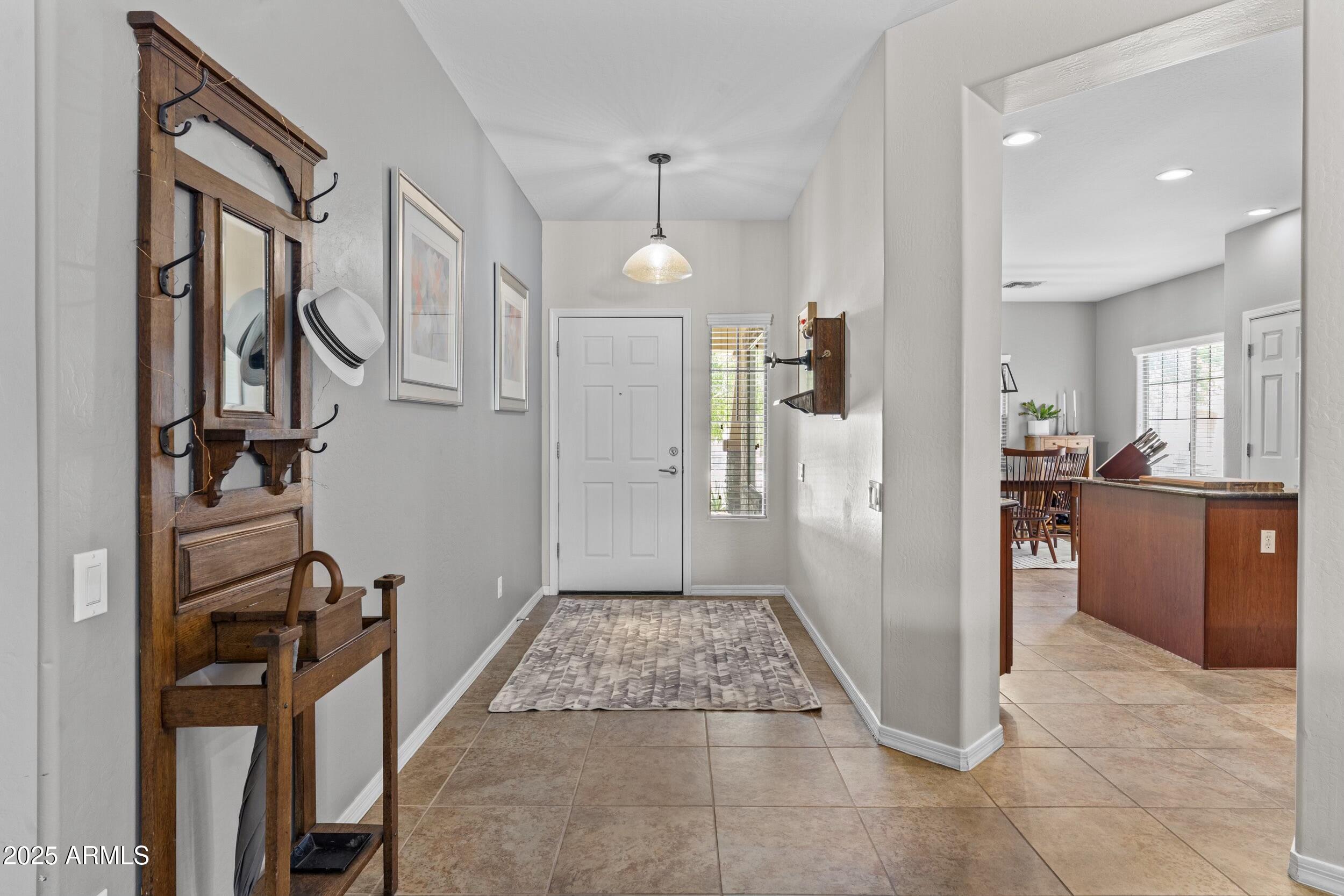 5303 West Hackamore Drive Phoenix, AZ 85083 - Photo 3 of 33 a view of a hallway with a livingroom and a kitchen