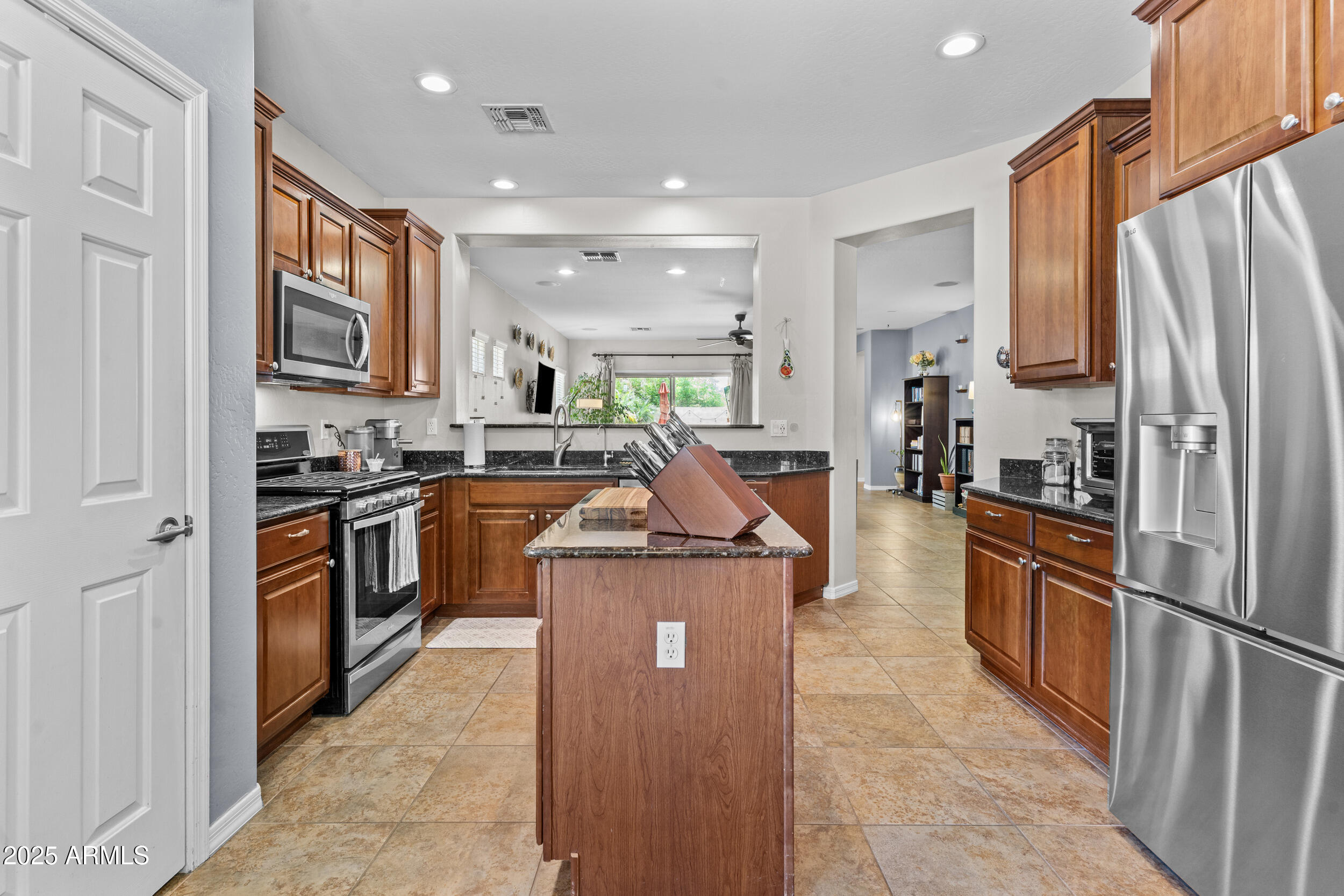 5303 West Hackamore Drive Phoenix, AZ 85083 - Photo 10 of 33 a kitchen with stainless steel appliances granite countertop a refrigerator a stove top oven a sink and dishwasher