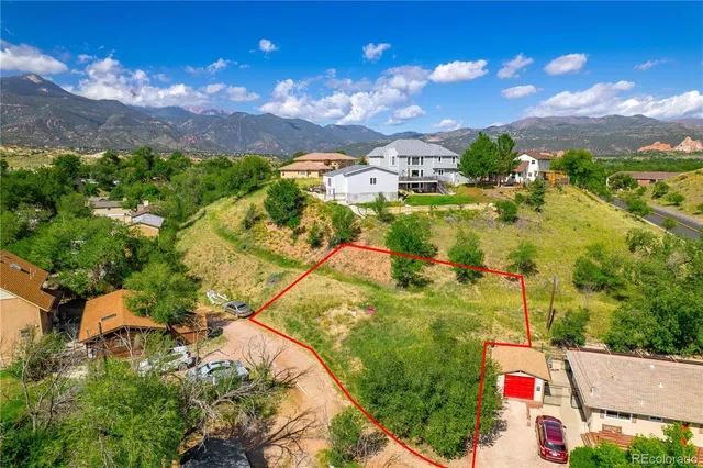 a view of swimming pool with a yard and mountain view in back
