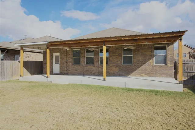 an aerial view of a house with a swimming pool patio and outdoor seating