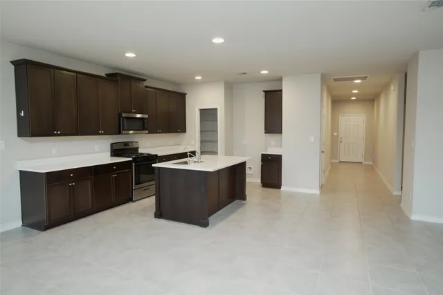 an empty room with windows and ceiling fan
