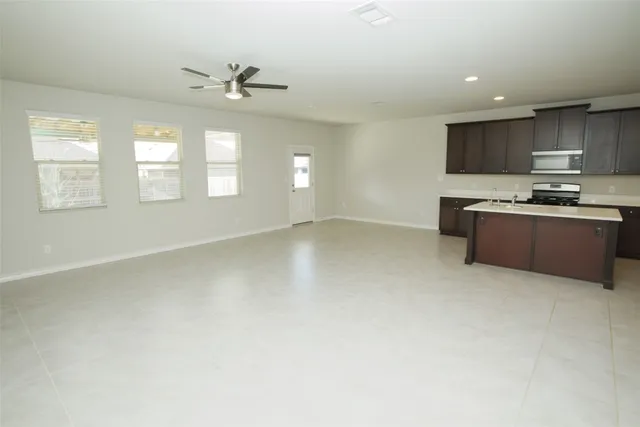 an empty room with kitchen view and a sink