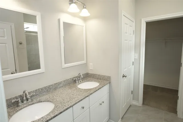 a bathroom with a shower and a sink