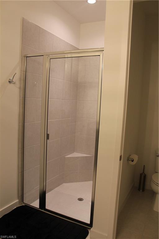 14601 Kingfisher Loop Naples, FL 34120 - Photo 11 of 20 a bathroom with a glass shower door