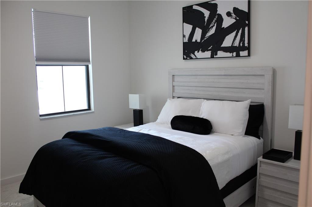 14601 Kingfisher Loop Naples, FL 34120 - Photo 12 of 20 a bedroom with a bed and a window
