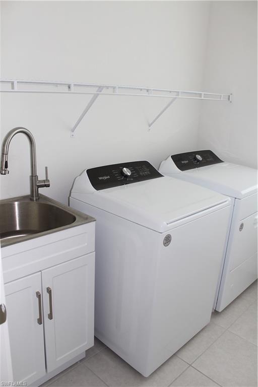 14601 Kingfisher Loop Naples, FL 34120 - Photo 19 of 20 a utility room with dryer and washer