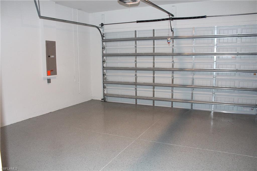 14601 Kingfisher Loop Naples, FL 34120 - Photo 20 of 20 a view of a room with racks on the wall