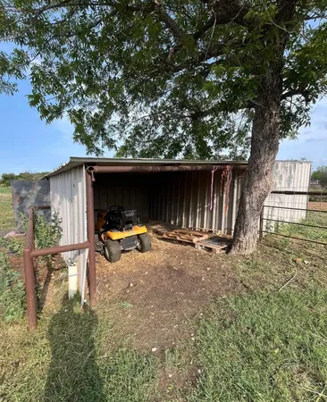 a view of backyard with cabin