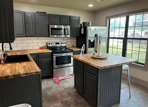 a kitchen with a sink stove and refrigerator
