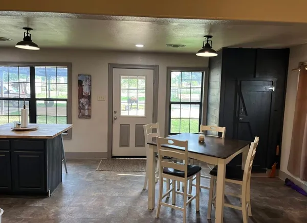 a view of a dining room with furniture and window