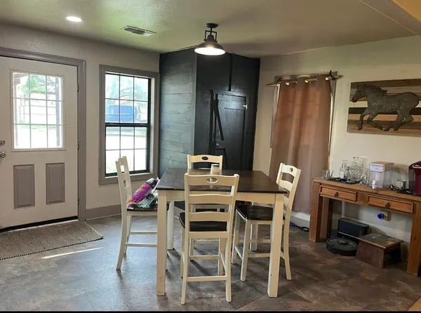a dining room with furniture and window
