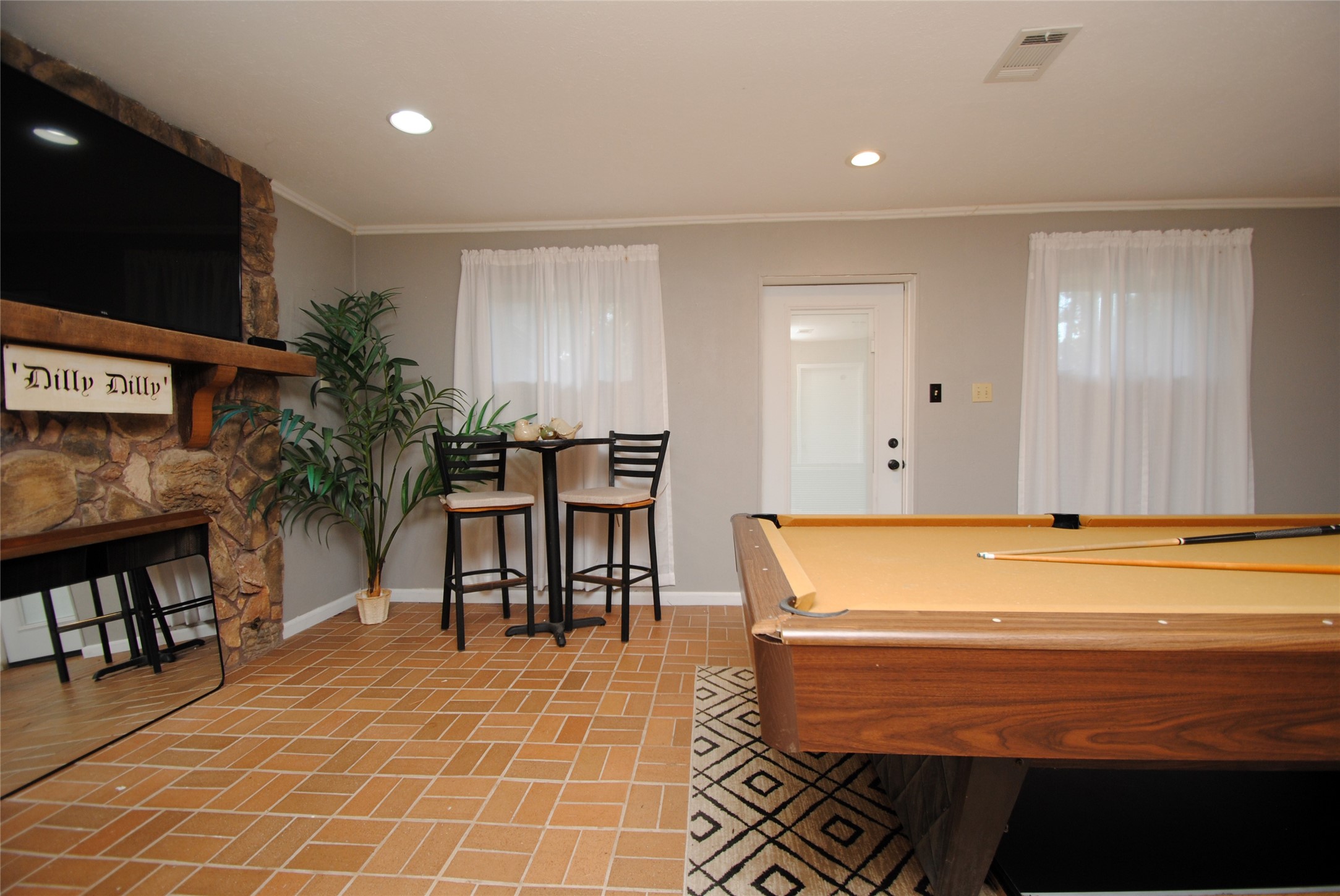 59 Paradise Loop Point Blank, TX 77364 - Photo 21 of 41 The game room also opens up to a large patio that overlooks the lake.