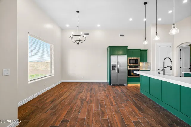 a kitchen with cabinets and chairs