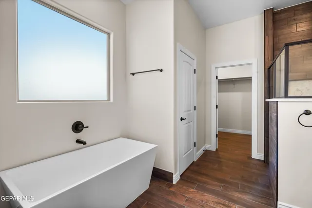 a view of a room with wooden floor and white doors