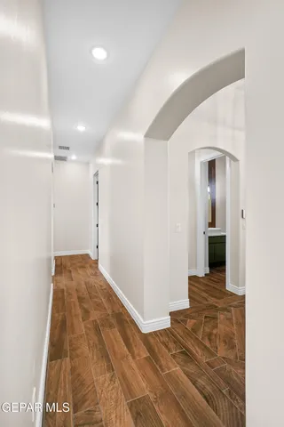 a view of a big room with wooden floor and a bathroom