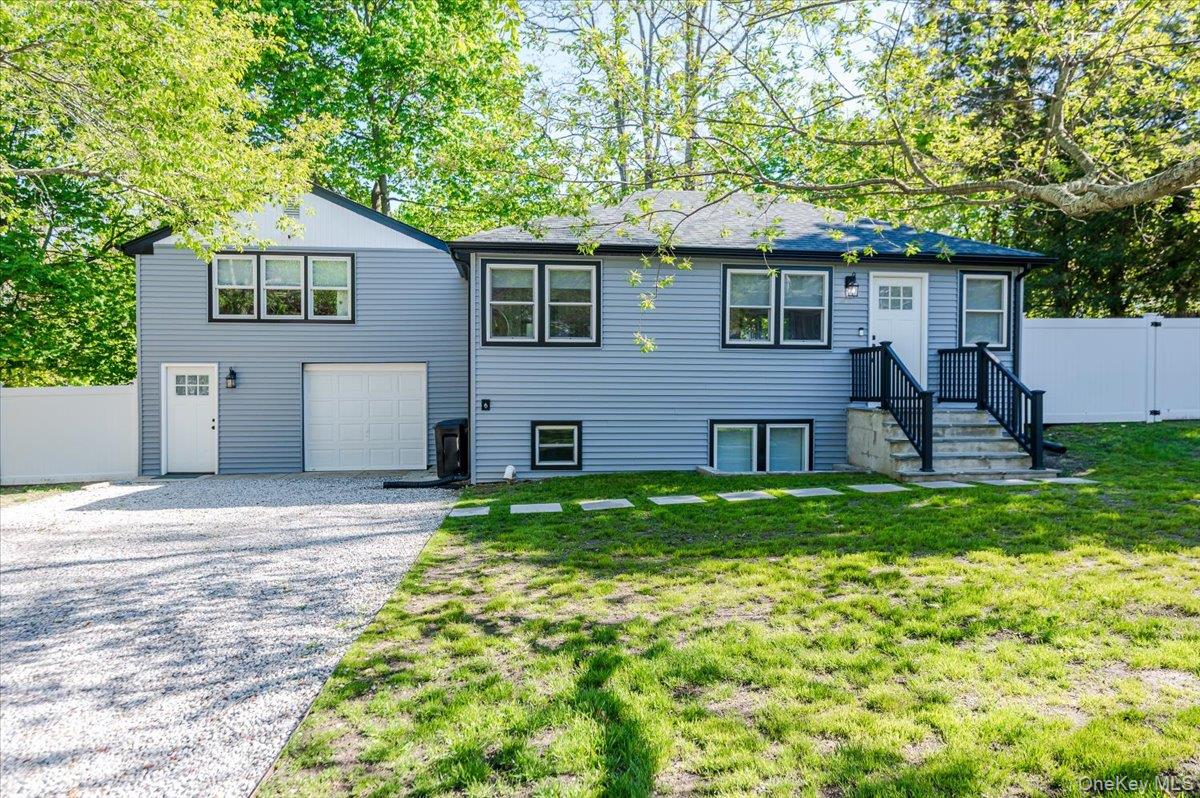 55 Hickory Road Rocky Point, NY 11778 - Photo 1 of 25 a front view of house with a garden and patio