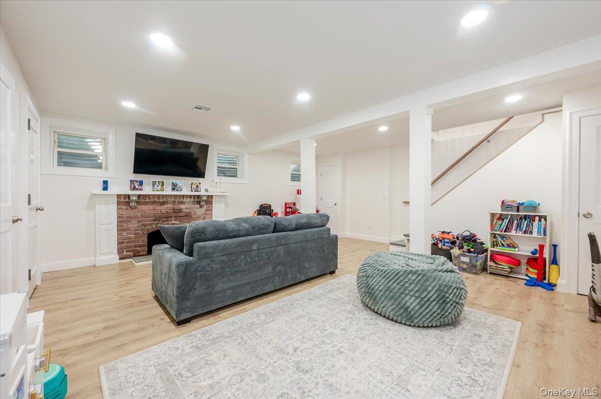 55 Hickory Road Rocky Point, NY 11778 - Photo 17 of 25 a living room with furniture and a flat screen tv