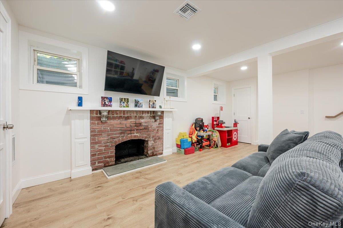 55 Hickory Road Rocky Point, NY 11778 - Photo 18 of 25 a living room with furniture and a flat screen tv