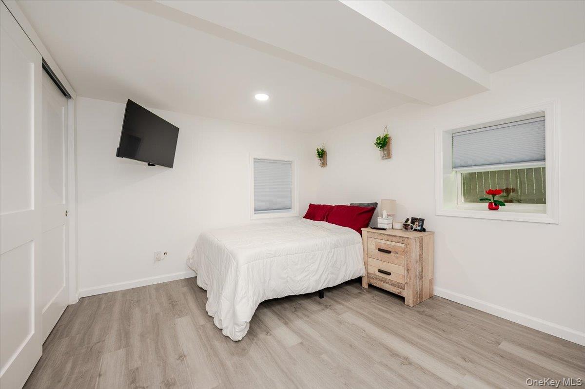 55 Hickory Road Rocky Point, NY 11778 - Photo 20 of 25 a bedroom with a bed and a flat screen tv