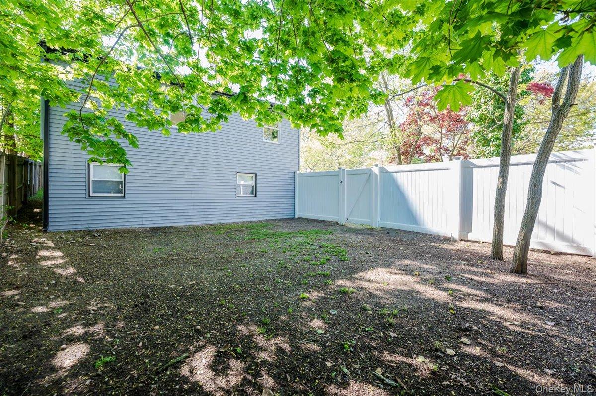 55 Hickory Road Rocky Point, NY 11778 - Photo 23 of 25 a backyard of a house with lots of green space