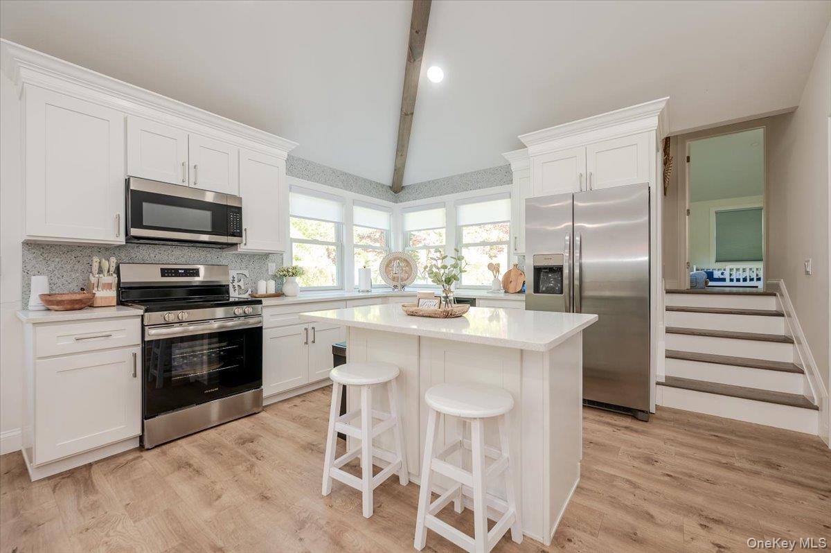 55 Hickory Road Rocky Point, NY 11778 - Photo 6 of 25 a kitchen with stainless steel appliances kitchen island granite countertop a stove top oven a sink and a refrigerator