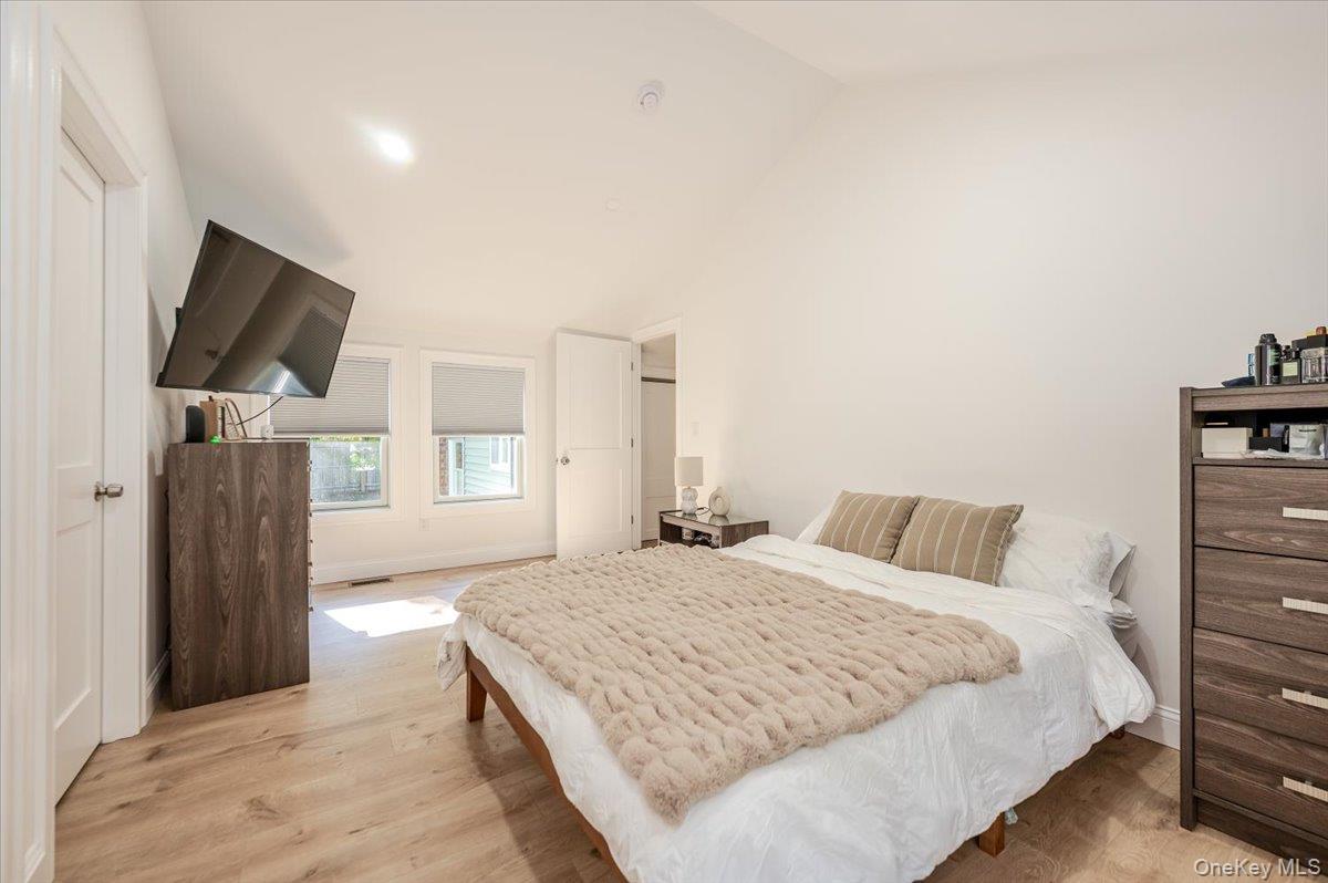 55 Hickory Road Rocky Point, NY 11778 - Photo 9 of 25 a spacious bedroom with a bed and a flat screen tv
