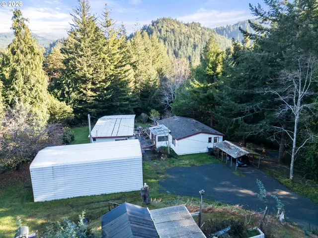 a living room with furniture a flat screen tv and a floor to ceiling window
