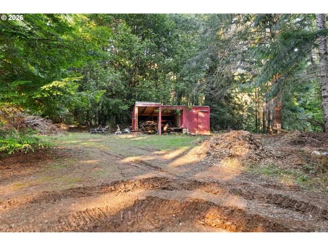 a view of a backyard with plants and brick wall