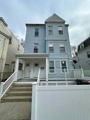 a view of a house with wooden stairs