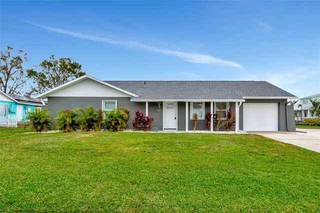 a front view of a house with a yard and porch