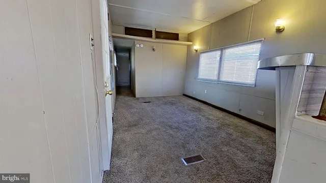 a white toilet sitting next to a bathroom sink and a mirror