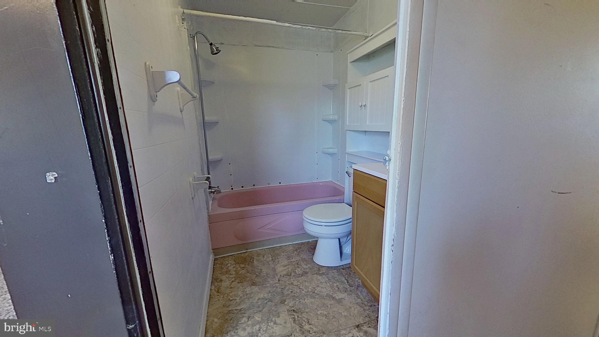 3230 Oakland Road, Unit 13 Dover, PA 17315 - Photo 6 of 7 a white toilet sitting next to a bathroom sink and a mirror