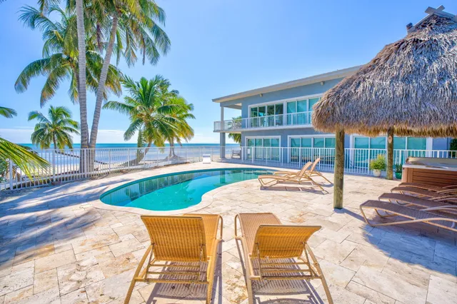 a living room with a bed furniture and a flat screen tv