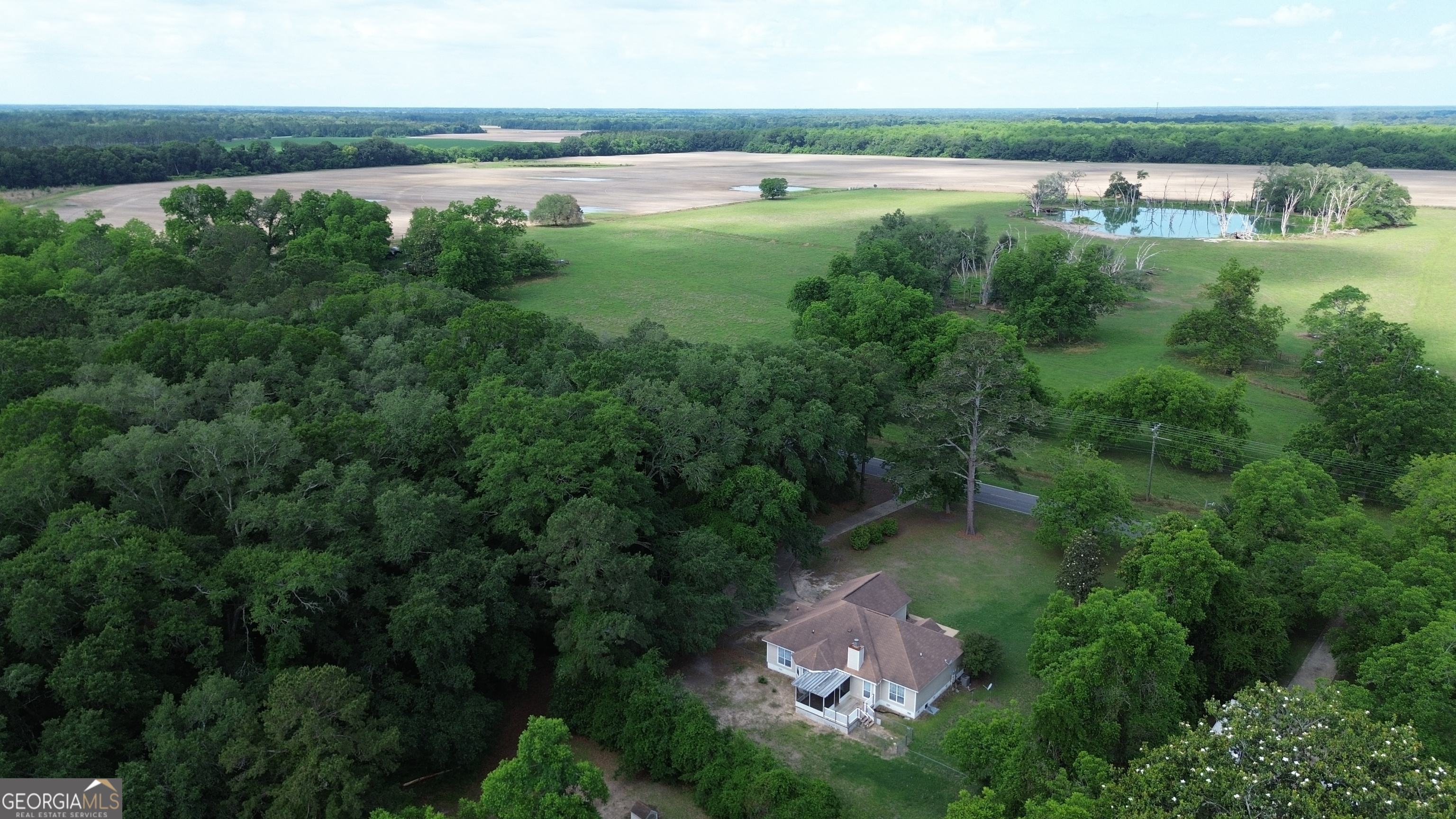 959 Lovers Lane Road Leesburg, GA 31763 - Photo 16 of 19 a backyard of a house with lots of green space and lake view in back