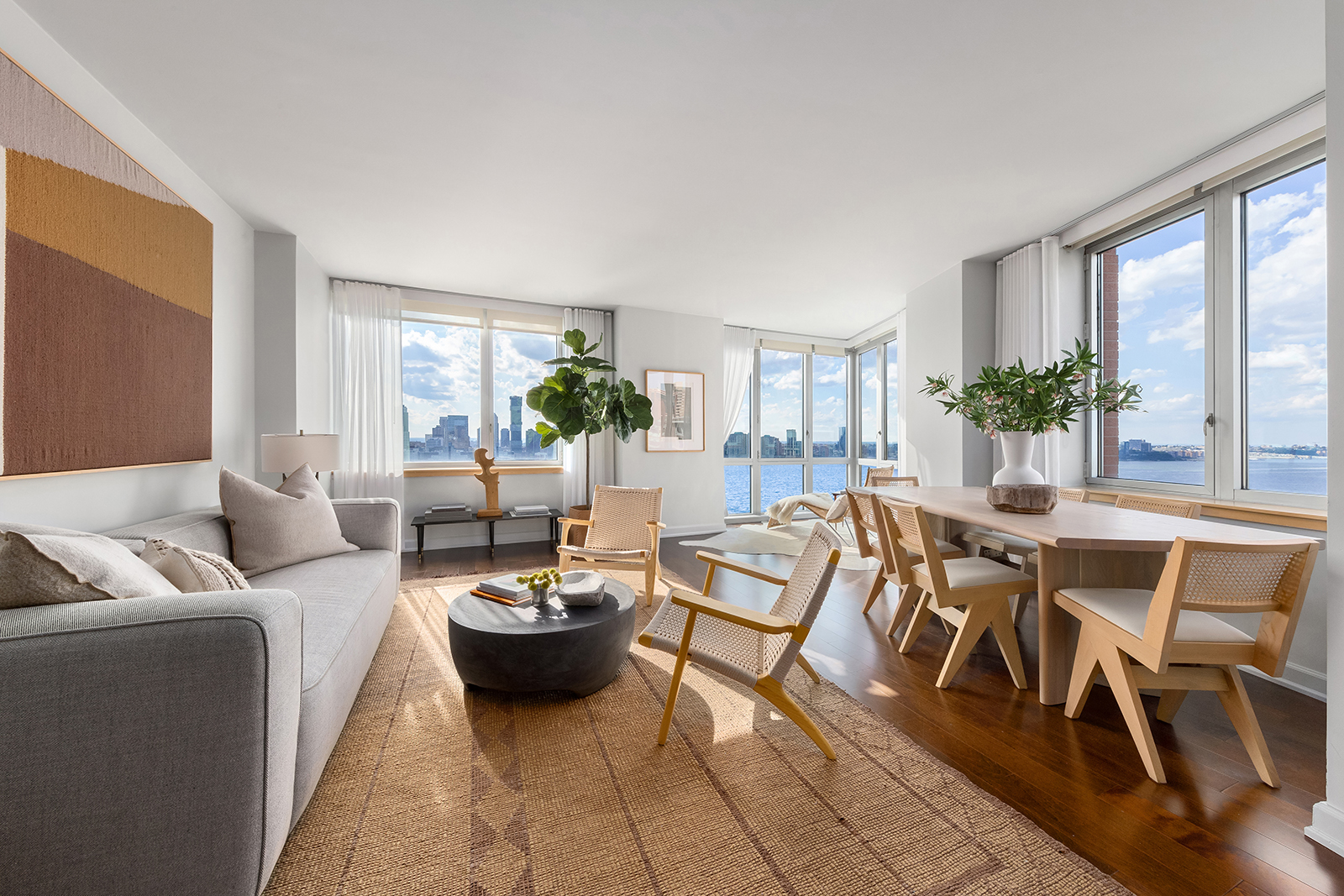 20 River Terrace, Unit 26B Manhattan, NY 10282 - Photo 13 of 25 a living room with furniture and a large window