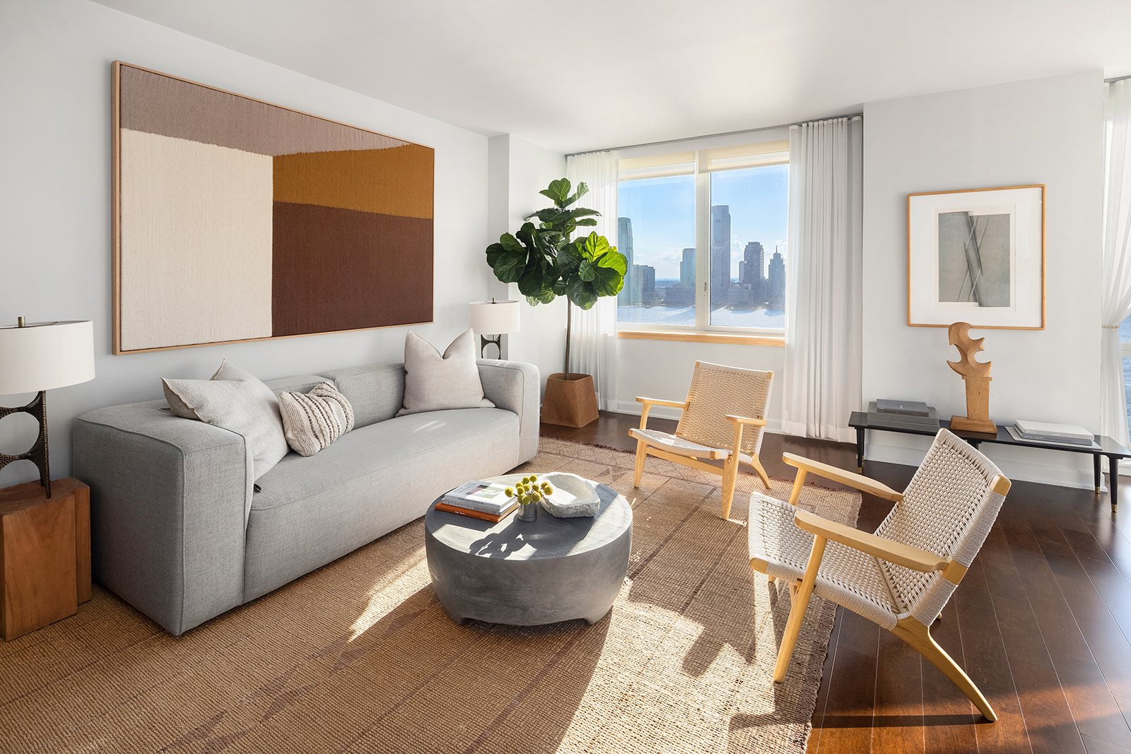 20 River Terrace, Unit 26B Manhattan, NY 10282 - Photo 14 of 25 a living room with furniture and a potted plant