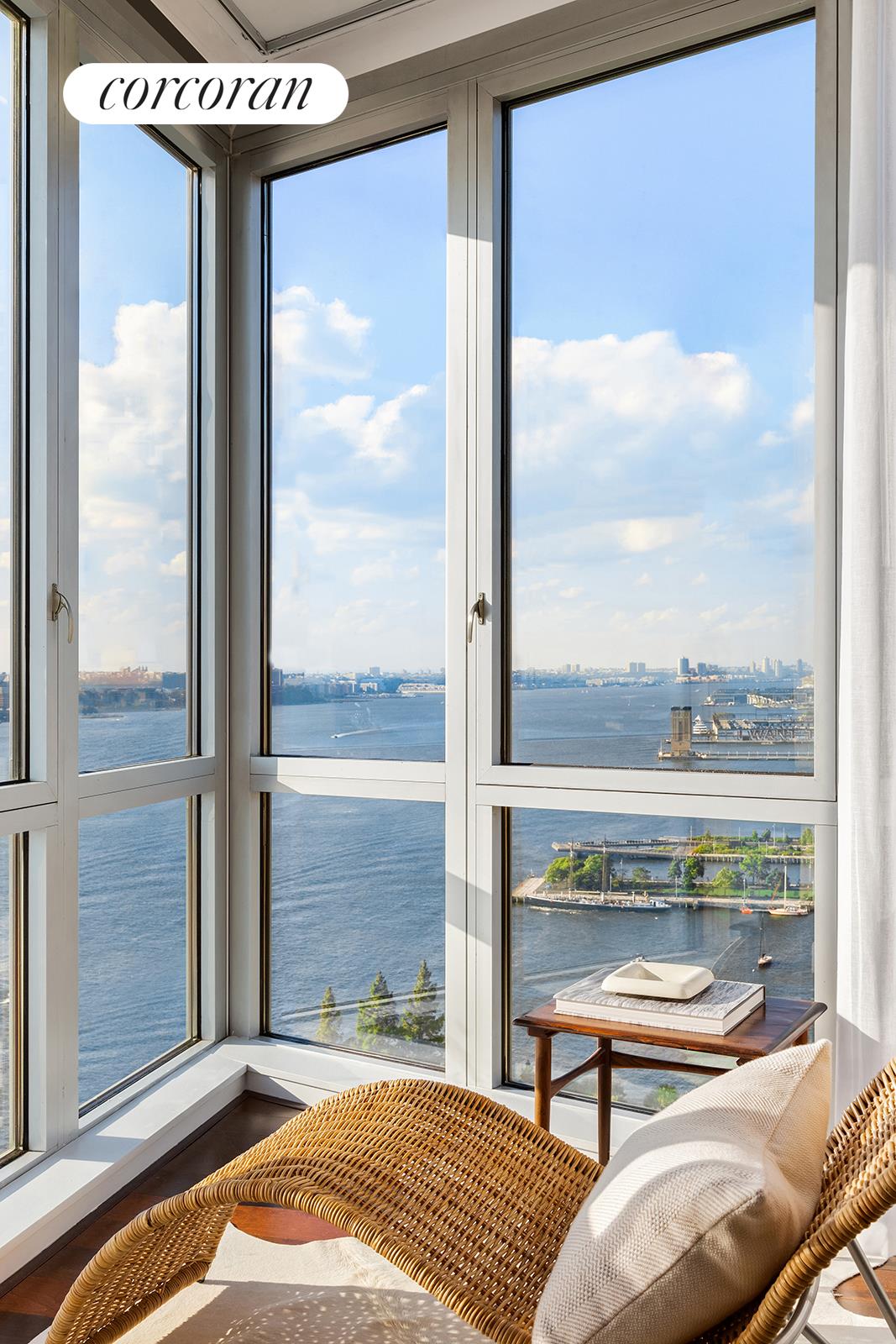 20 River Terrace, Unit 26B Manhattan, NY 10282 - Photo 3 of 25 a balcony view with a couch and wooden floor