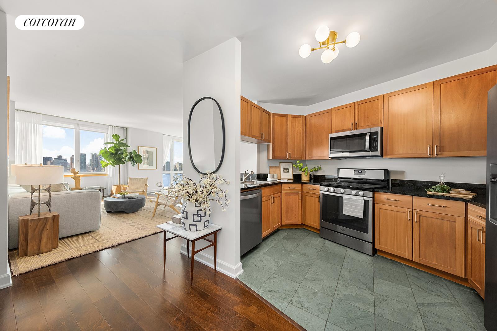 20 River Terrace, Unit 26B Manhattan, NY 10282 - Photo 4 of 25 a living room with furniture a fireplace and a chandelier