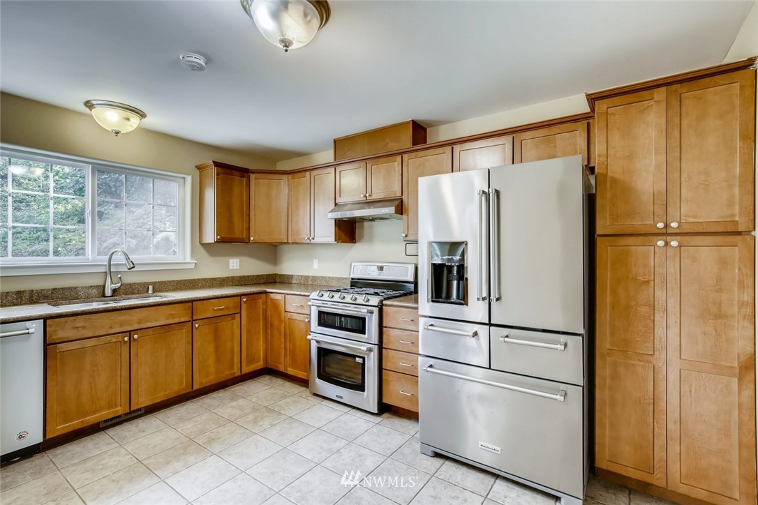 2903 Connors Road Snohomish, WA 98290 - Photo 8 of 39 a kitchen with stainless steel appliances granite countertop a refrigerator sink and cabinets